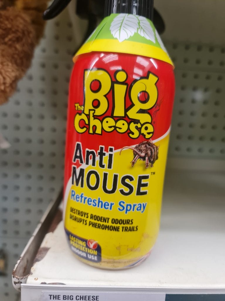 Sover Travel - A yellow and red can of The Big Cheese Anti Mouse Refresher Spray is on a store shelf. The label claims it destroys rodent odours and disrupts pheromone trails, offering lasting protection.