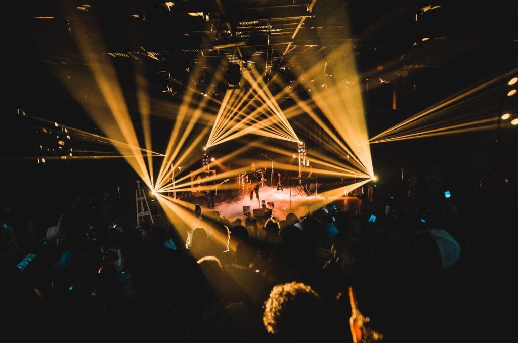 **Alt Text:** A vibrant concert scene with bright lights and a captivated audience. **Caption:** Experience the energy of live music, where mindful moments meet the thrill of performance. **Image Description:** A lively concert with dynamic lighting and an engaged crowd, showcasing the joy of live music experiences.